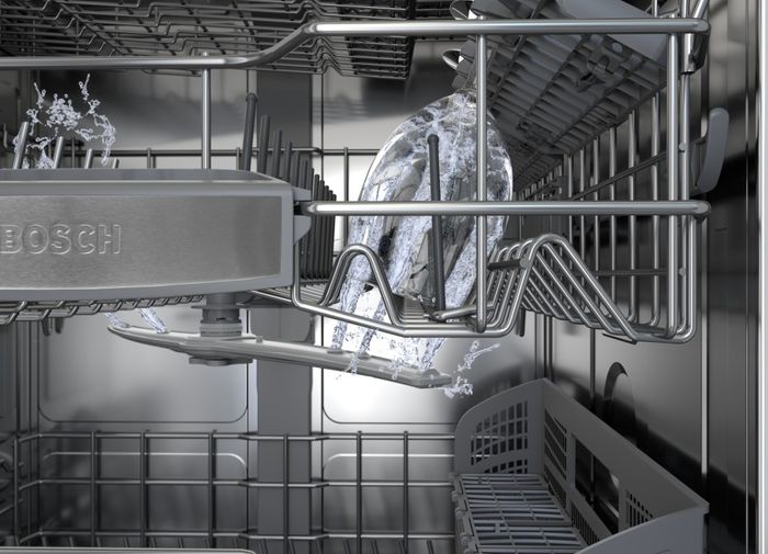 Interior of a stainless steel Bosch dishwasher.